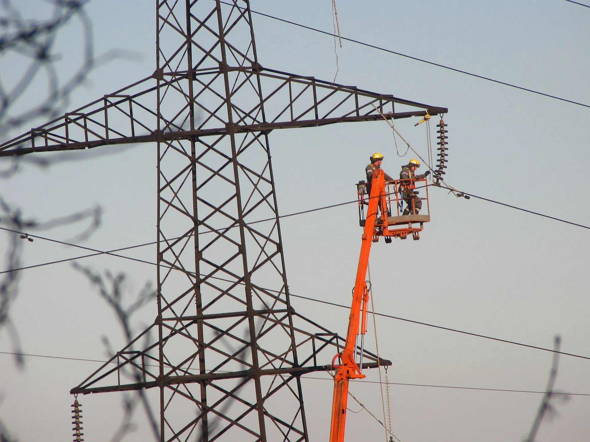 High-voltage electricity pylons carrying power lines across a field in Ukraine