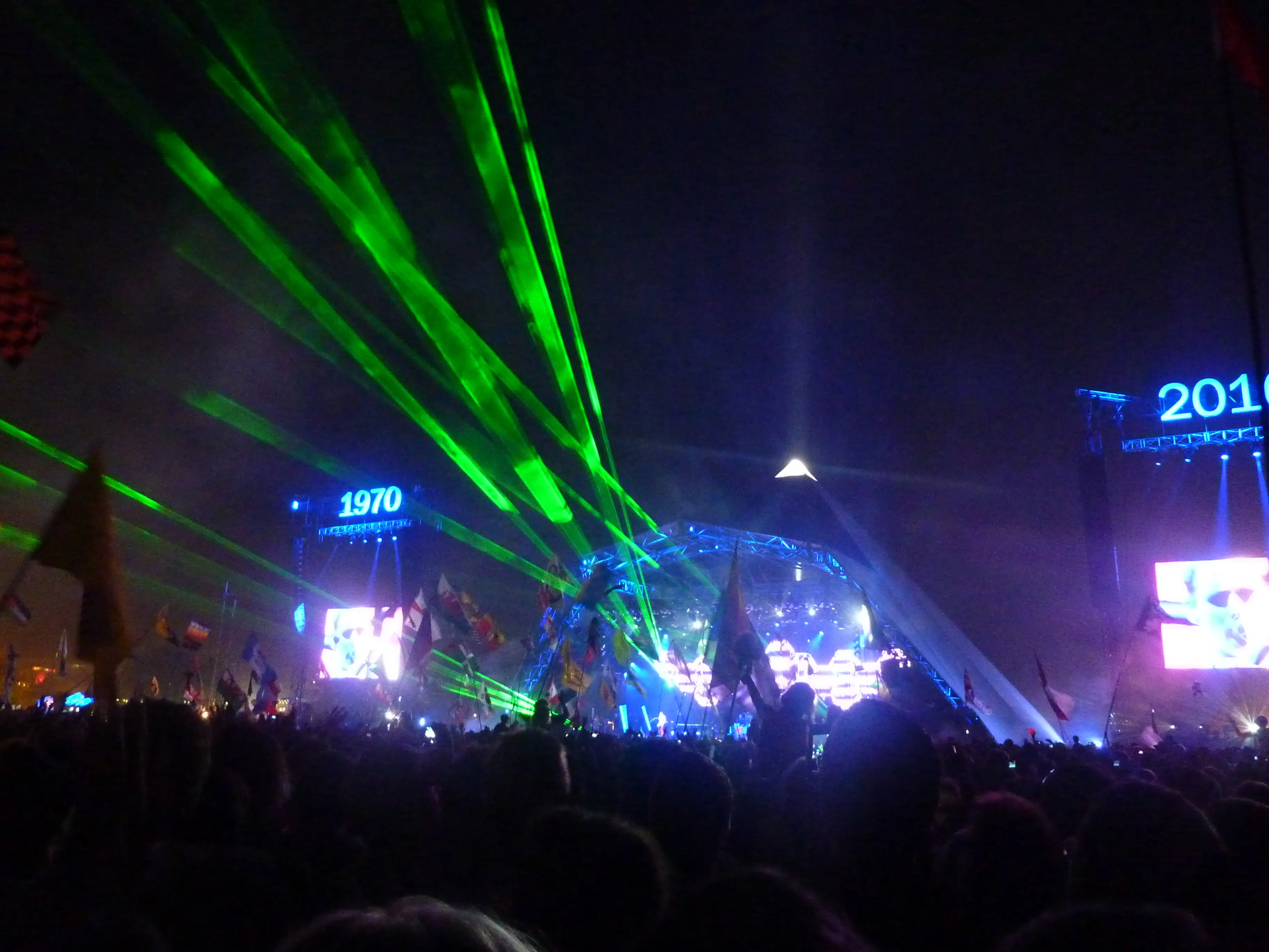 Crowd gathered before Glastonbury Festival's Pyramid Stage at dusk