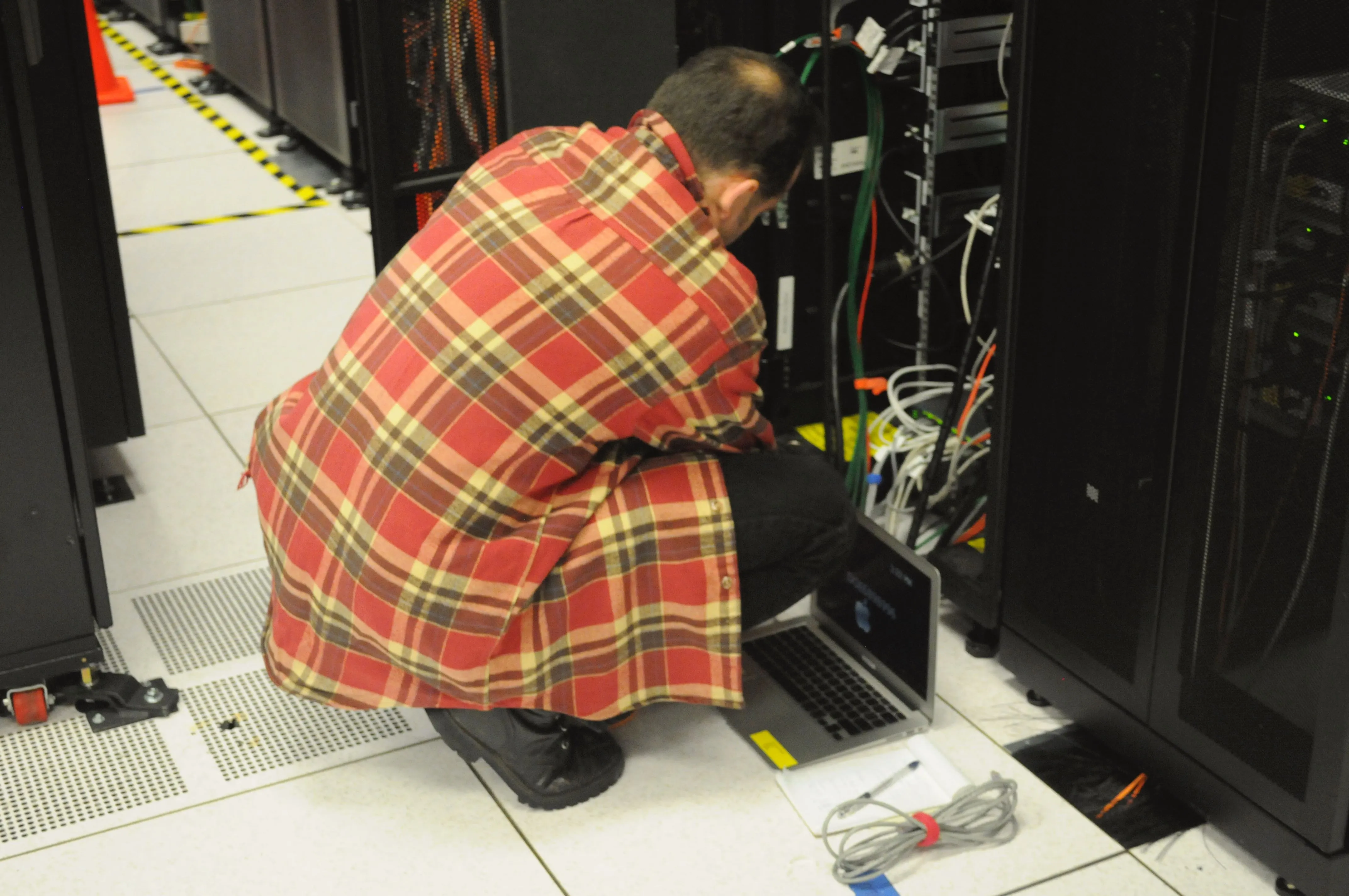 Technician working on server racks inside a data centre